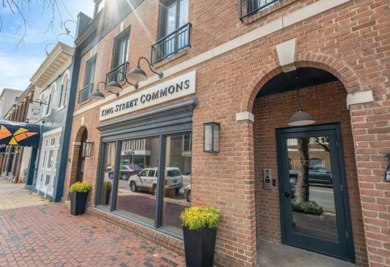 Exterior brick facade of King Street Commons with large windows and street-level entrance.