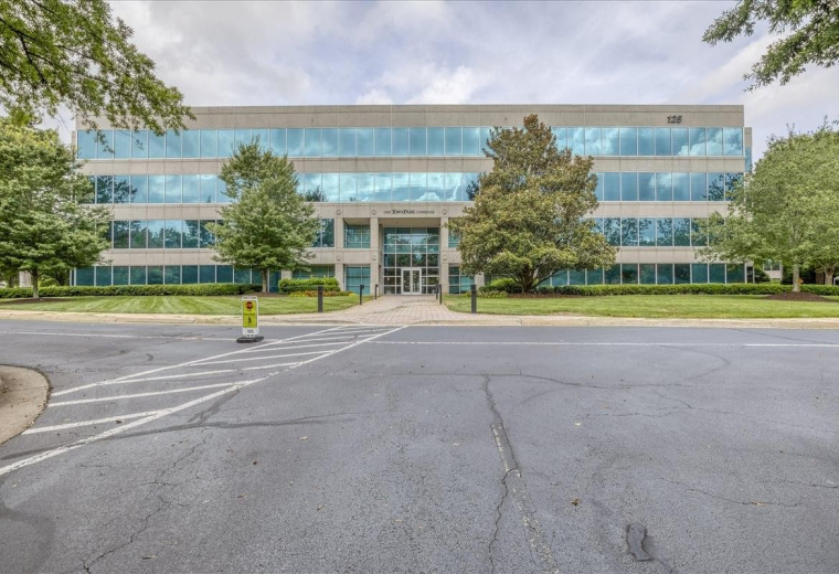 Exterior view of the four-story glass and stone facade at 125 TownPark Drive, Suite 300, Town Park Center.