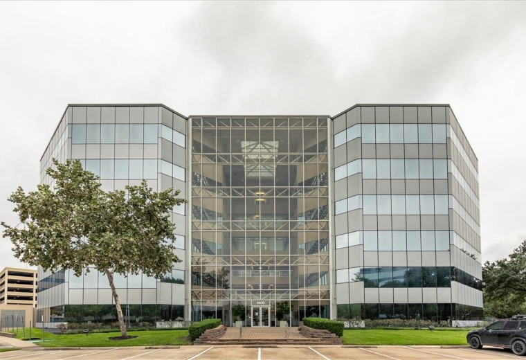 Exterior view of the multi-story glass facade building at 1400 Broadfield.