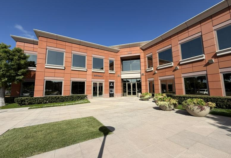 Exterior view of the brick facade and main entrance at 1400 Newport Center Drive, Suite 100 (14N).