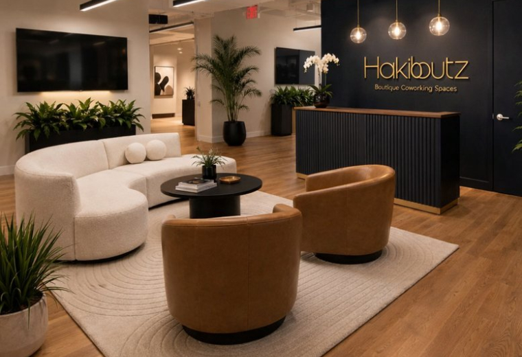 Reception area at 151, West 26th Street, 6th Floor with a dark wood desk and curved white sofa.
