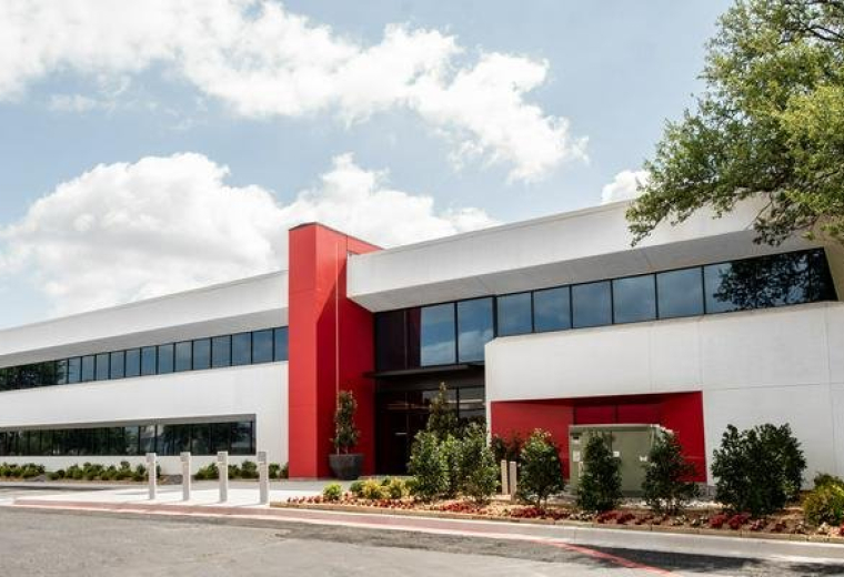 Exterior view of the white and red facade at 17250 Dallas Parkway.