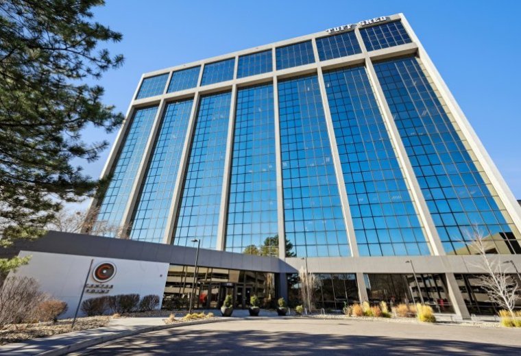 Exterior view of the glass-facade 1777 South Harrison Street building under a clear blue sky.
