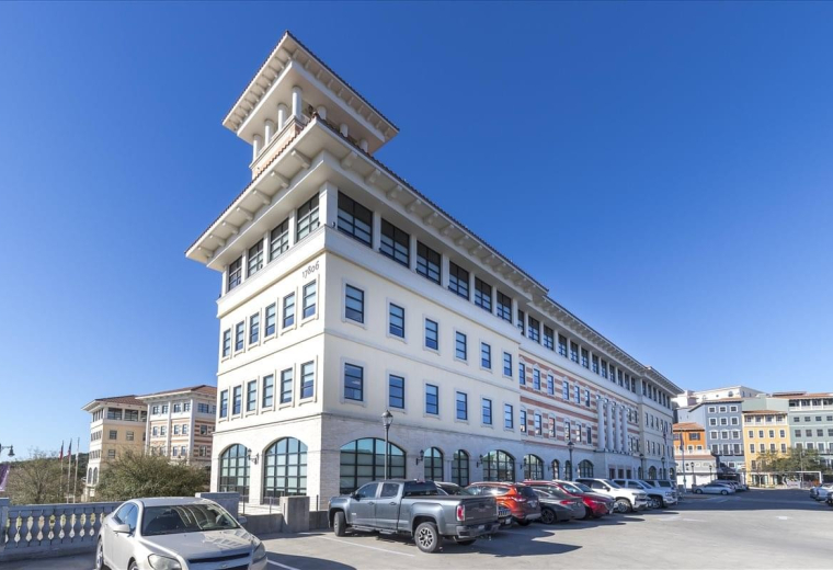 Exterior view of the multi-story stone facade building at 17806 Interstate Highway 10.