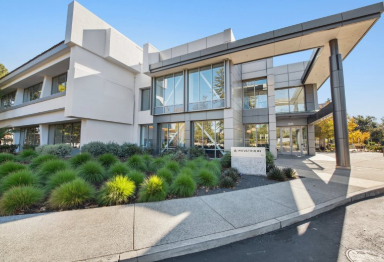 Exterior view of the modern, glass-facade building at 1881 Page Mill Road.