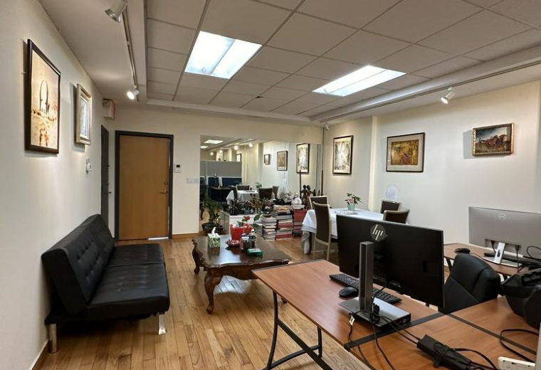 Spacious main office area at 19 West 26th Street, Suite 503 featuring wood floors and several work stations.