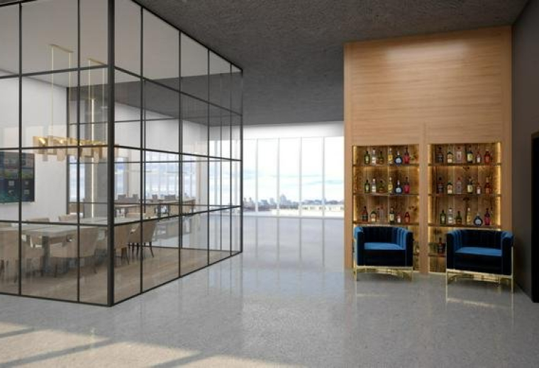 Spacious reception area at 200 Kent Avenue Offices featuring a glass-walled meeting room and velvet armchairs.