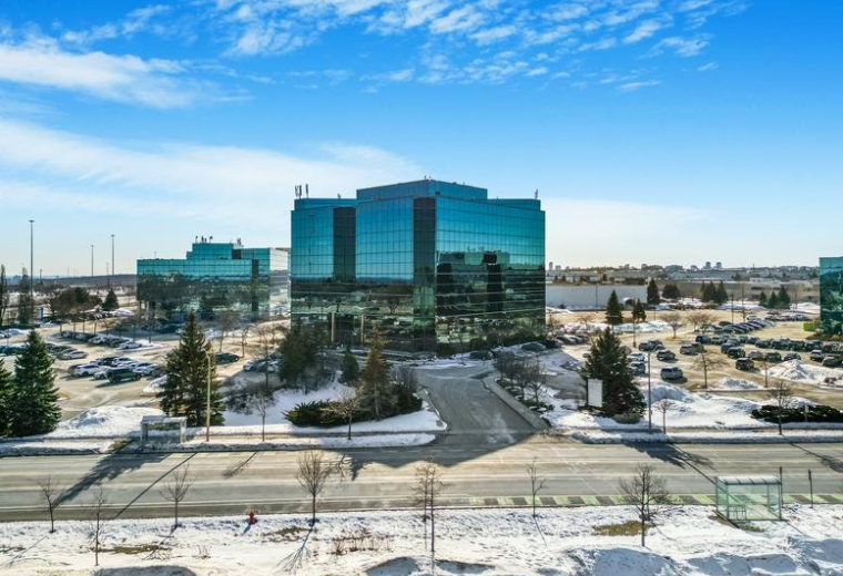 Exterior view of the glass-facade office building at 2020 Winston Park Drive.