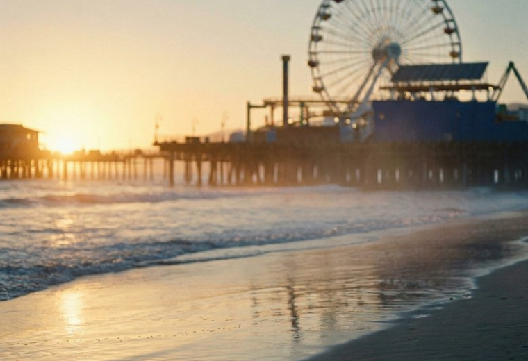 Scenic sunset view of a coastal pier with a large ferris wheel at 235, Queen Street.