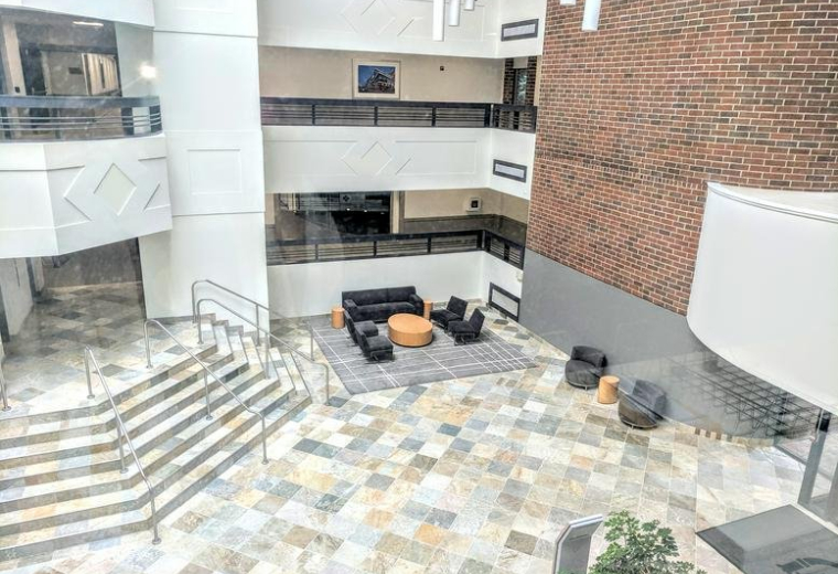 Spacious multi-story atrium lobby at 25, Braintree Hill Office Park, Suite 200 with stone floors and lounge seating.