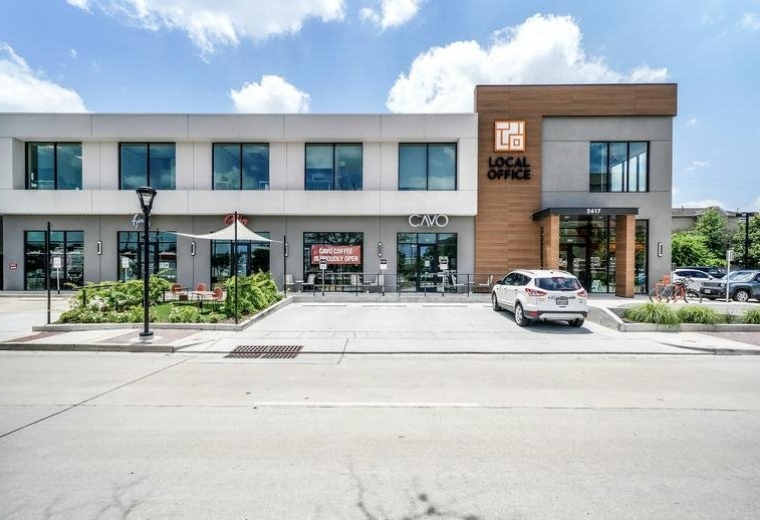 Exterior view of the modern two-story brick and white facade building at 2617 Bissonnet Street.