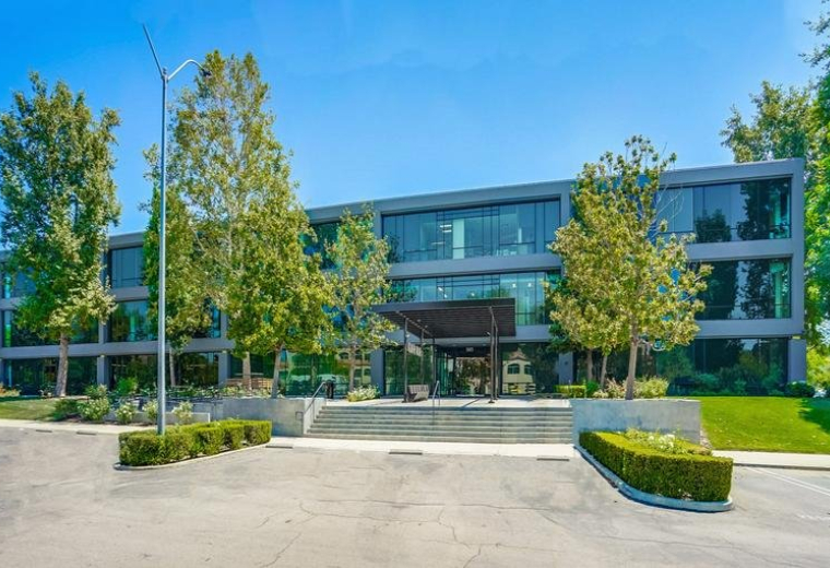 Exterior facade of the glass and concrete Westlake Corporate Plaza building.