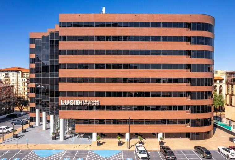 Exterior view of the brick and glass office building at 2626 Cole Avenue, Suite No. 300 and No. 400.