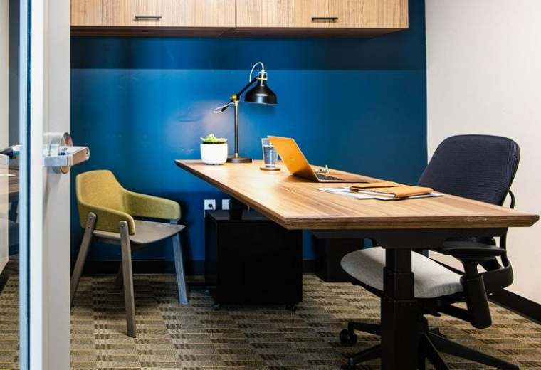 Conference room looking out onto a wooded landscape through large windows.