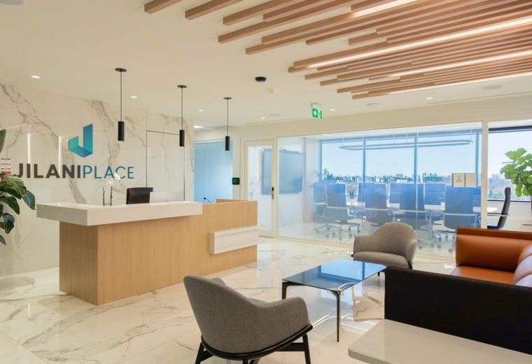 Spacious reception area at 295, The West Mall with wooden accents, marble floors, and lounge seating.