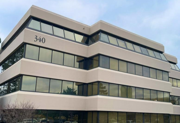 Exterior view of the multi-story glass building at 340 West Butterfield Road.