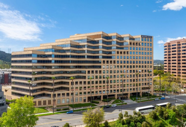 Exterior view of the multi-story stone and glass building at 3400 Riverside Drive.