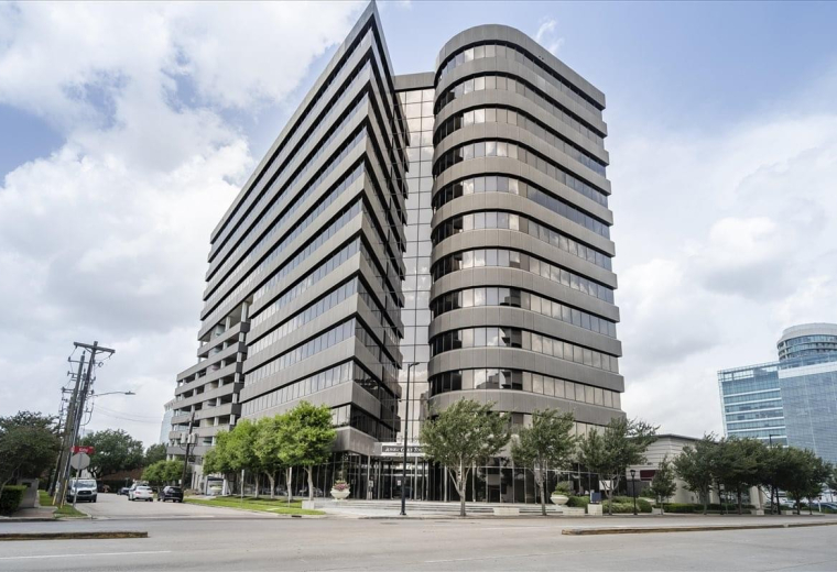 Exterior view of the multi-story glass facade of The Upper Kirby Business Center.