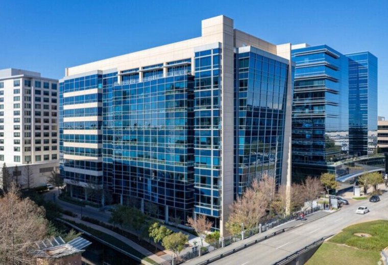 Exterior view of the modern blue glass-facade building at 4 Waterway Square Place, Suite 400.