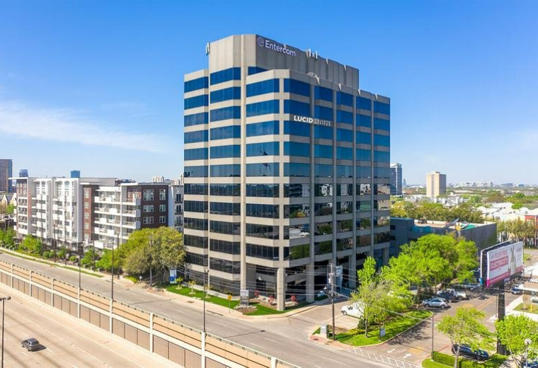 Exterior view of the multi-story glass and concrete building at 4131 N Central Expressway.