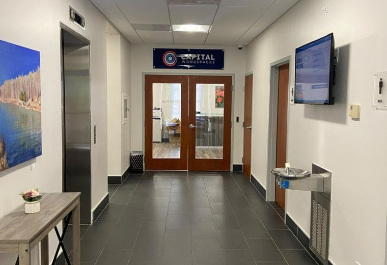 Hallway leading to the entrance of 4315, 50th Street Northwest with elevator and water station.