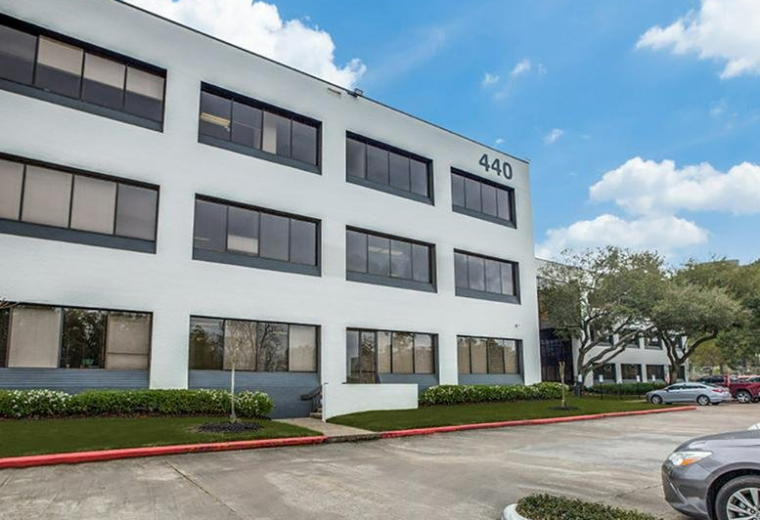 Exterior view of the white facade building with number 440 at 440 Benmar Drive.