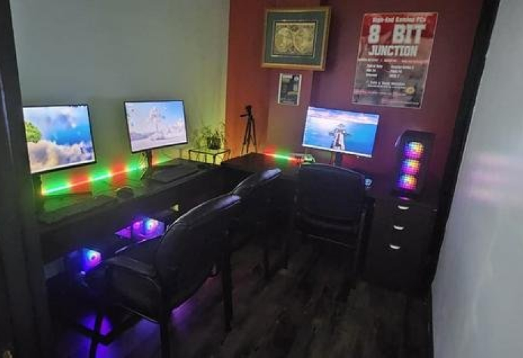 Spacious three-monitor gaming or creative setup with vibrant RGB lighting at 480 Chrysler Drive Unit 39.