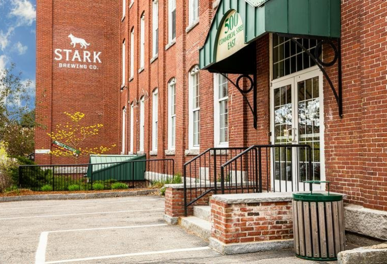 Brick exterior and main entrance of 500 North Commercial Street, Suite 502 with green awning.