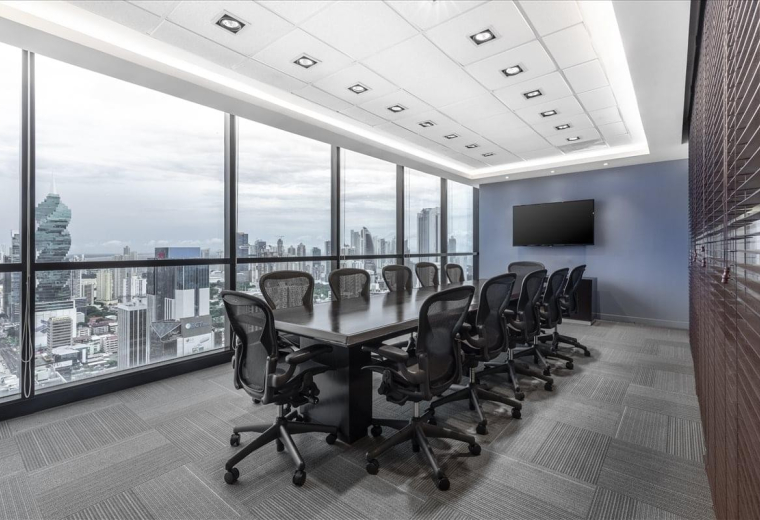 Large boardroom with a long table and panoramic city views.