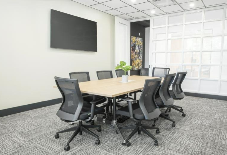 Modern open-plan workspace featuring a core values wall graphic and polished floors.