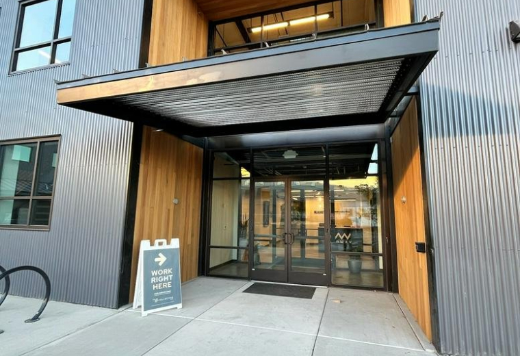 Exterior entrance of the modern industrial-style building at Work-Collective Midway.