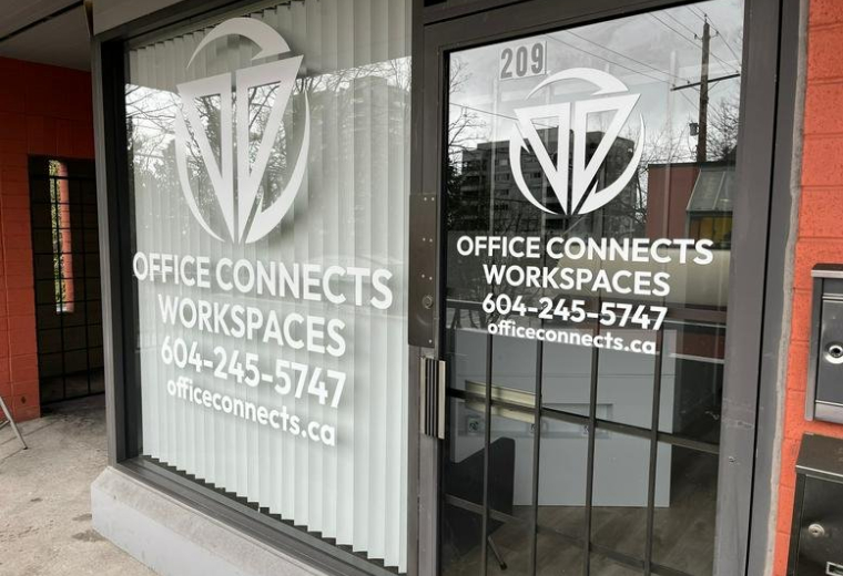 Exterior view of Office Connects Workspaces entrance with large logo on the window.