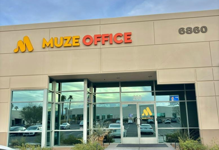 Exterior facade and glass entrance of Muze Office, 6860 Bermuda Rd.