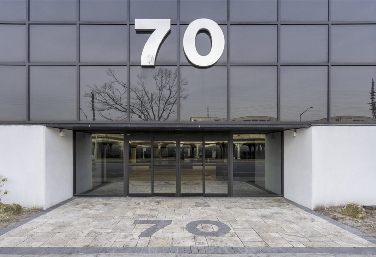Glass entrance of the building at 70 East Sunrise Highway, Suite 500.
