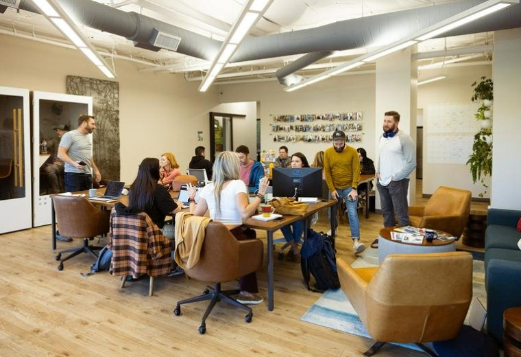 Spacious open-plan coworking area with wooden floors and collaborative seating at 705, Gold Lake Drive.