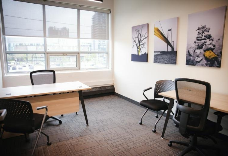 Spacious private office at 72, Victoria Street South,300 featuring a large window and guest seating.
