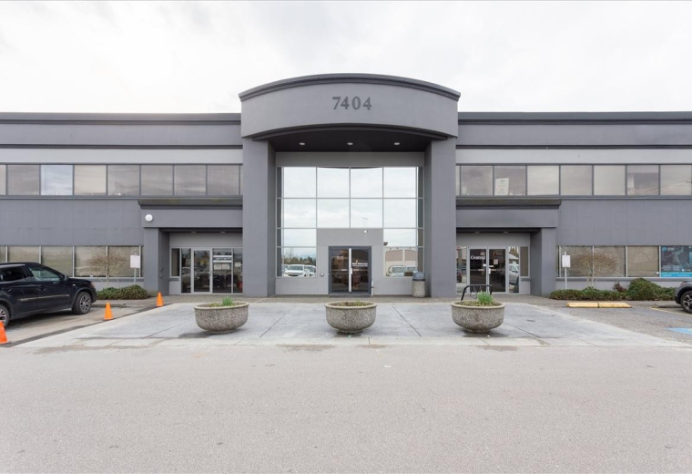 Exterior view of the professional grey facade at 7404 King George Boulevard, Suite 200.