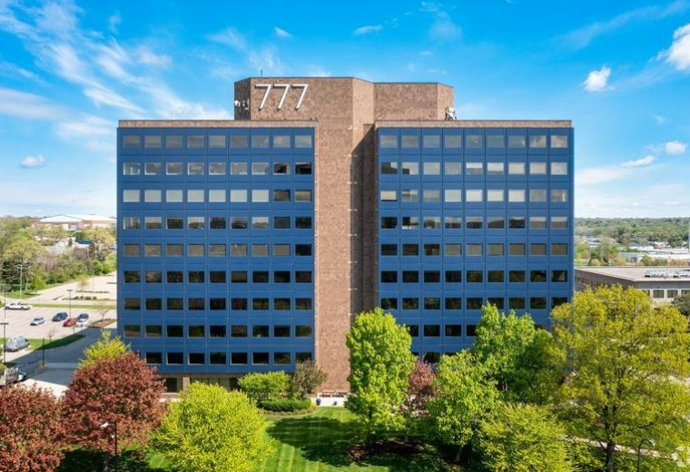 Front view of the professional dark blue multi-story office building.
