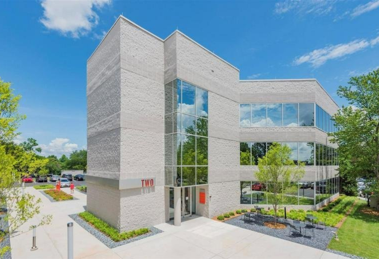 Exterior view of the modern stone and glass facade of 777 Lowndes Hill Road.