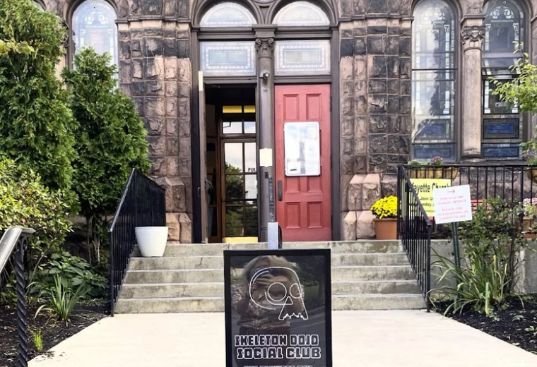Stone facade entrance of the Skeleton Dojo Social Club at 875 Elmwood Avenue.