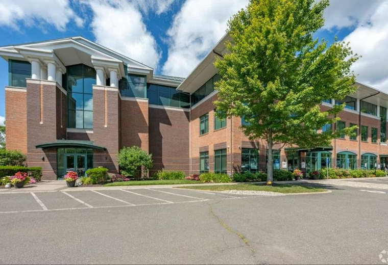Exterior view of the multi-story brick and glass office building at 93 Lake Avenue.