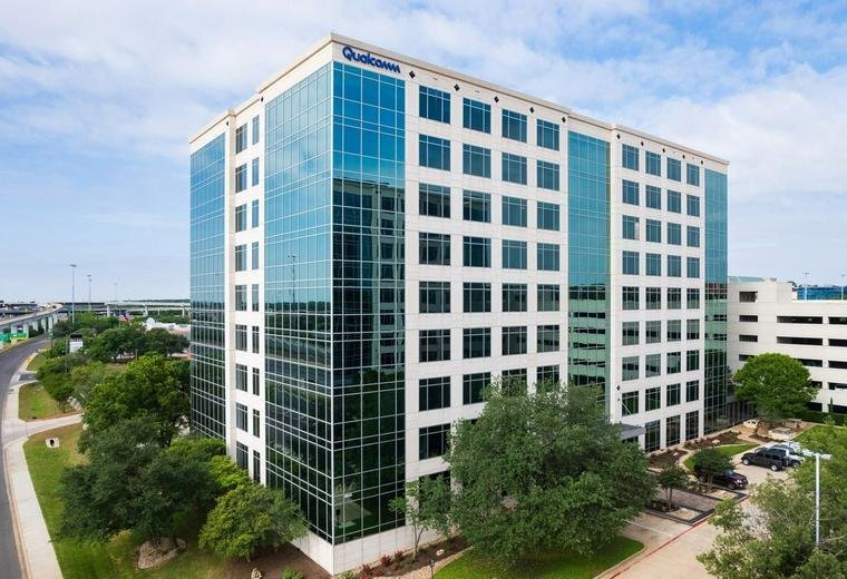 Exterior view of the multi-story glass and stone building at 9600, North Mopac Expressway, Suite 900.