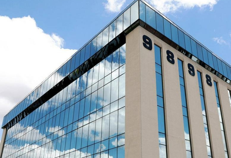 Exterior view of the glass and stone facade at 9898 Bissonnet Street.