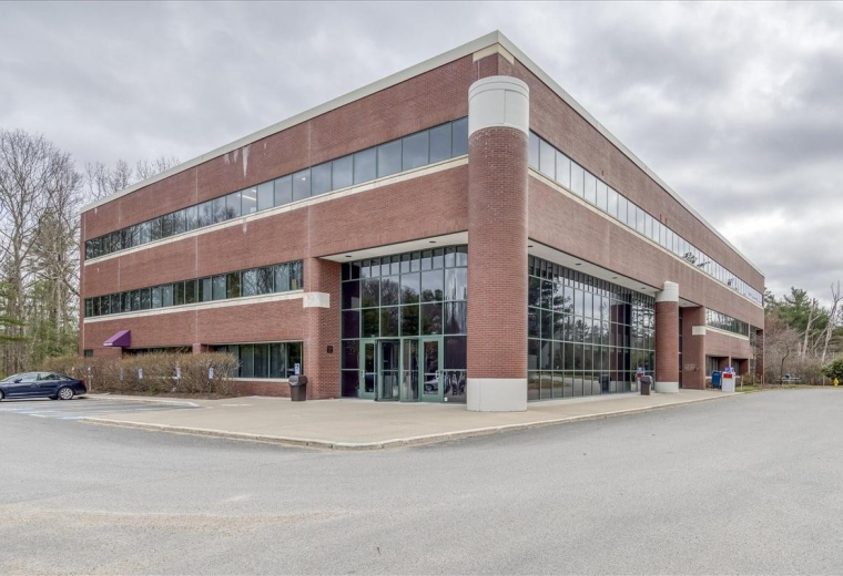 Exterior brick and glass facade of the 99 Derby Street, Suite 200 building.