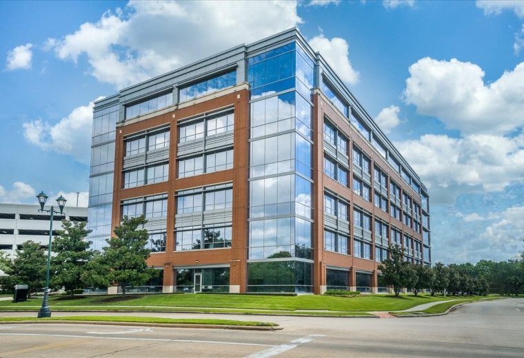Exterior view of the brick and glass facade of Three Sugar Creek Center.