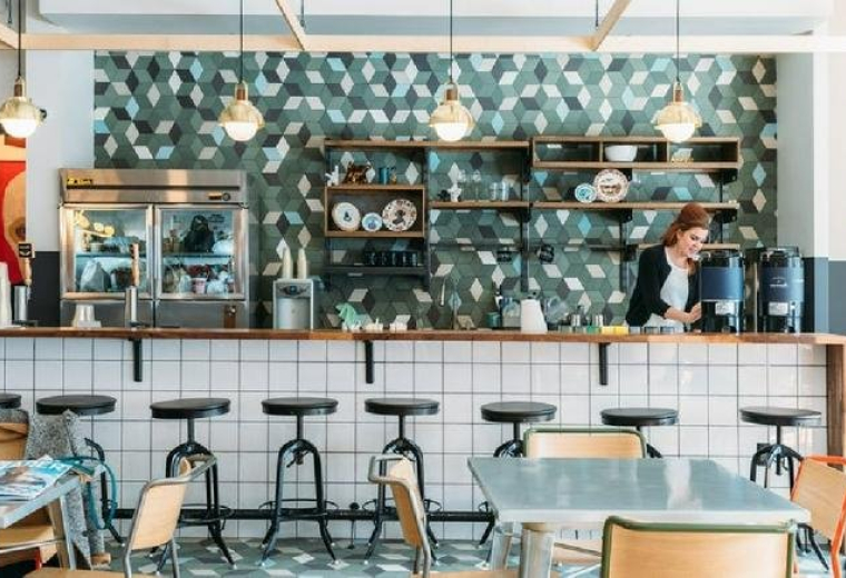 Bright coworking hub with long wooden tables and industrial decor at Williamsburg, 134 North 4th Street.