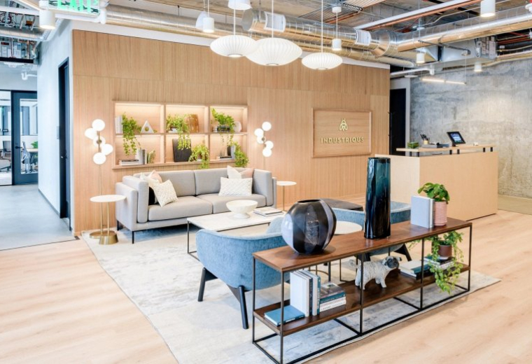 Spacious reception area with a wood-paneled feature wall and modern grey seating at Rainier Square.