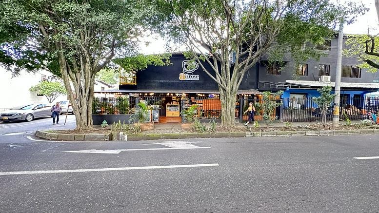 Exterior view of the black and orange facade building at # 2A-26, Carrera 65.