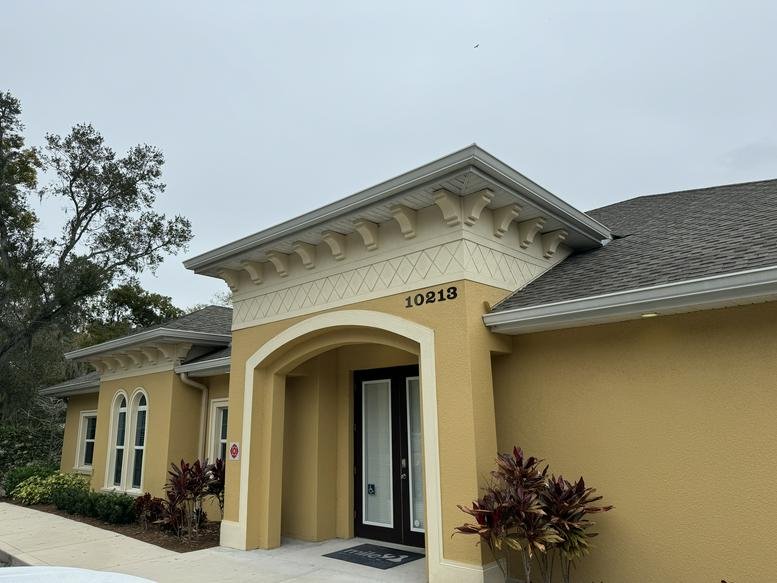 Exterior view of the Mediterranean-style building entrance at 10213 Wilsky Boulevard.