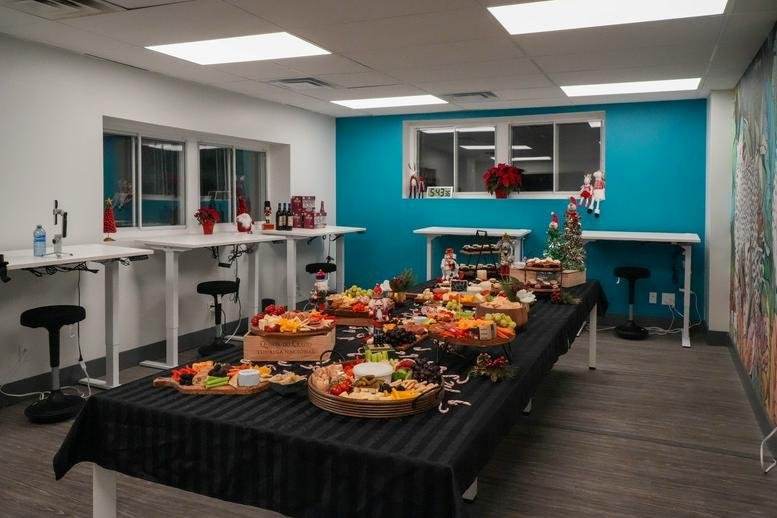 Spacious communal area at 10225, Yonge Street with a large food spread and turquoise feature wall.